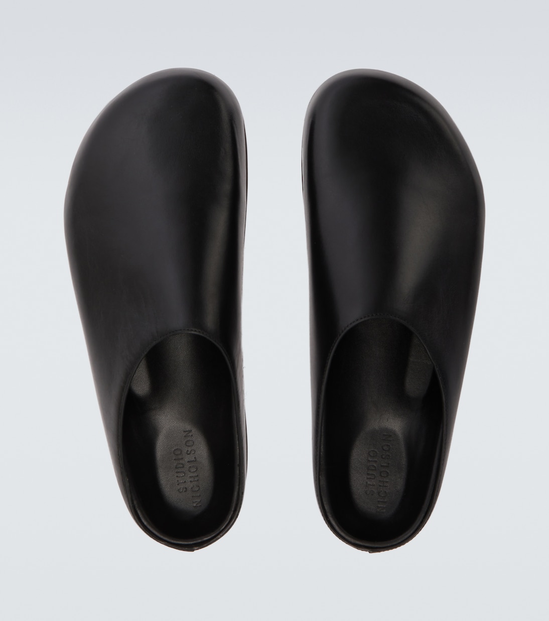 Wearing leather mules | Studio Nicholson