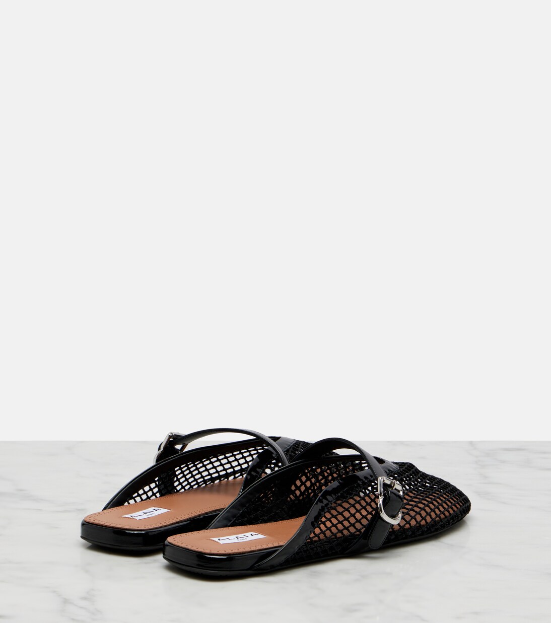 Fishnet leather-trimmed mules | Alaïa