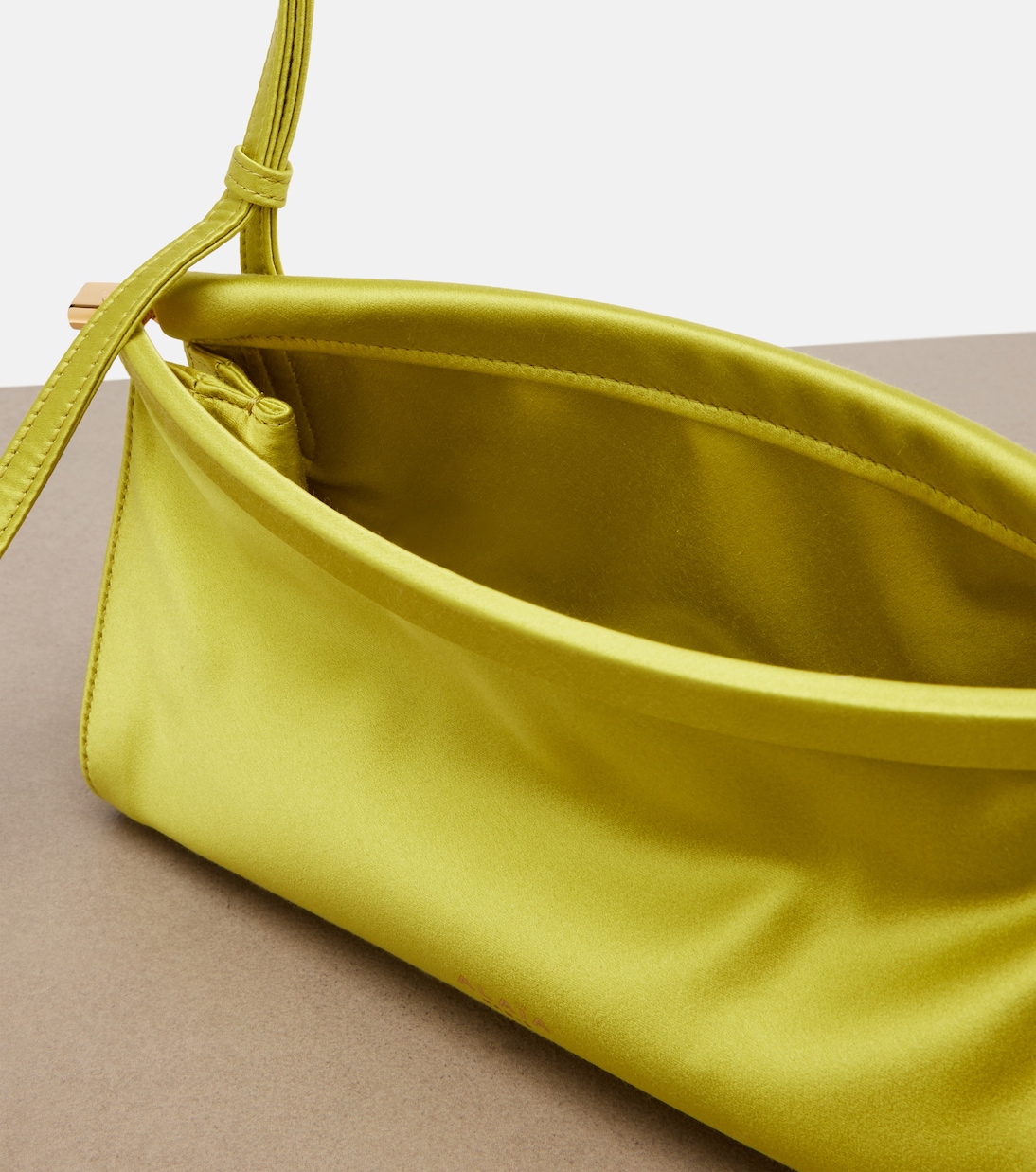 Le Click East West Small leather-trimmed satin shoulder bag | Alaïa