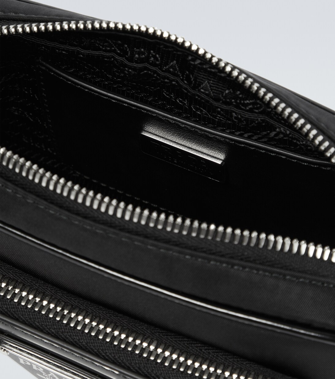 Leather-trimmed crossbody bag | Prada