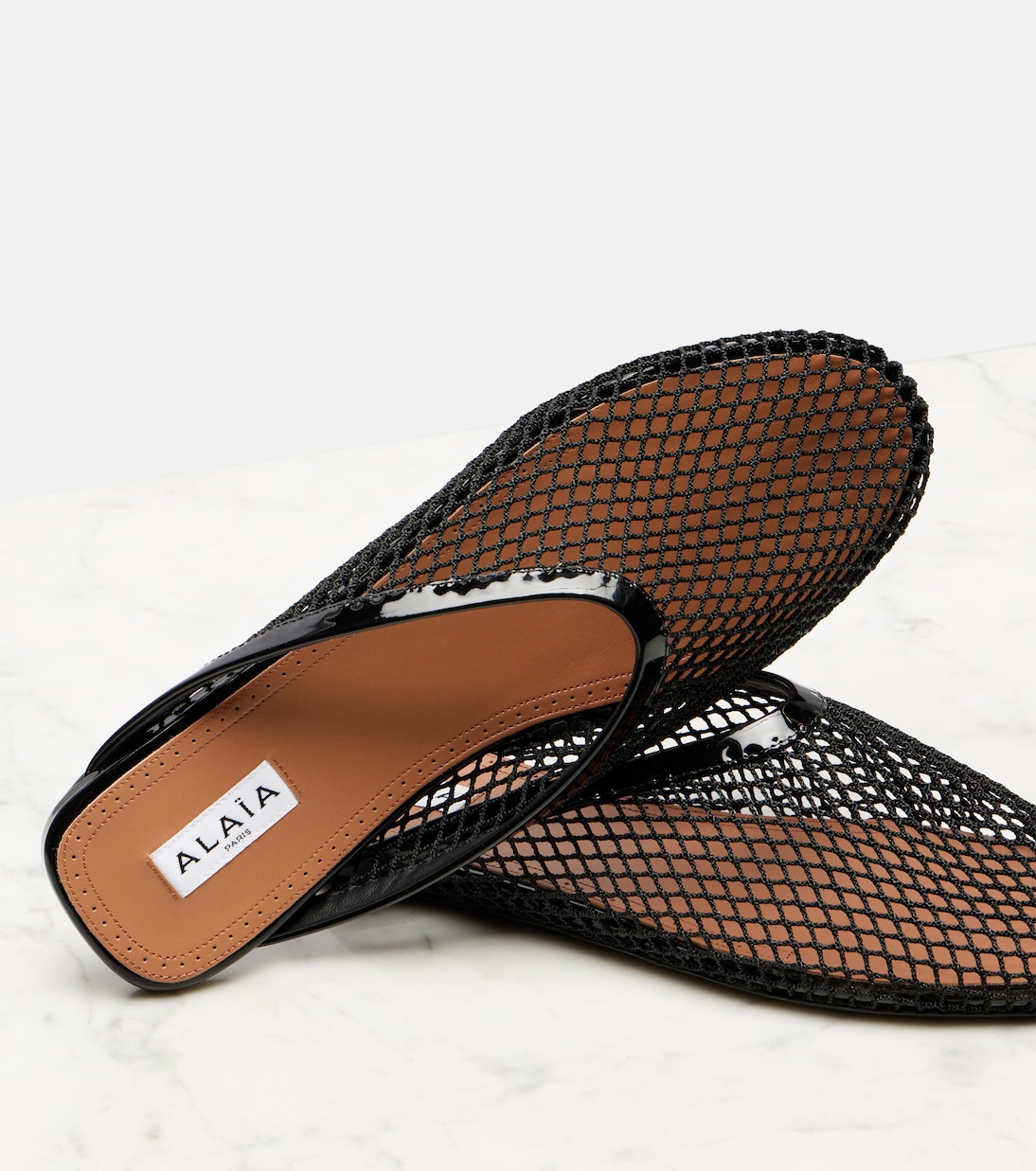 Patent leather-trimmed fishnet mules | Alaïa