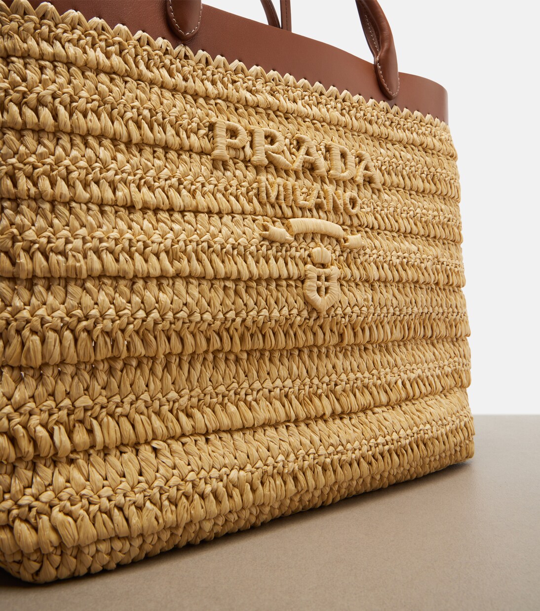 Medium leather-trimmed raffia tote bag | Prada