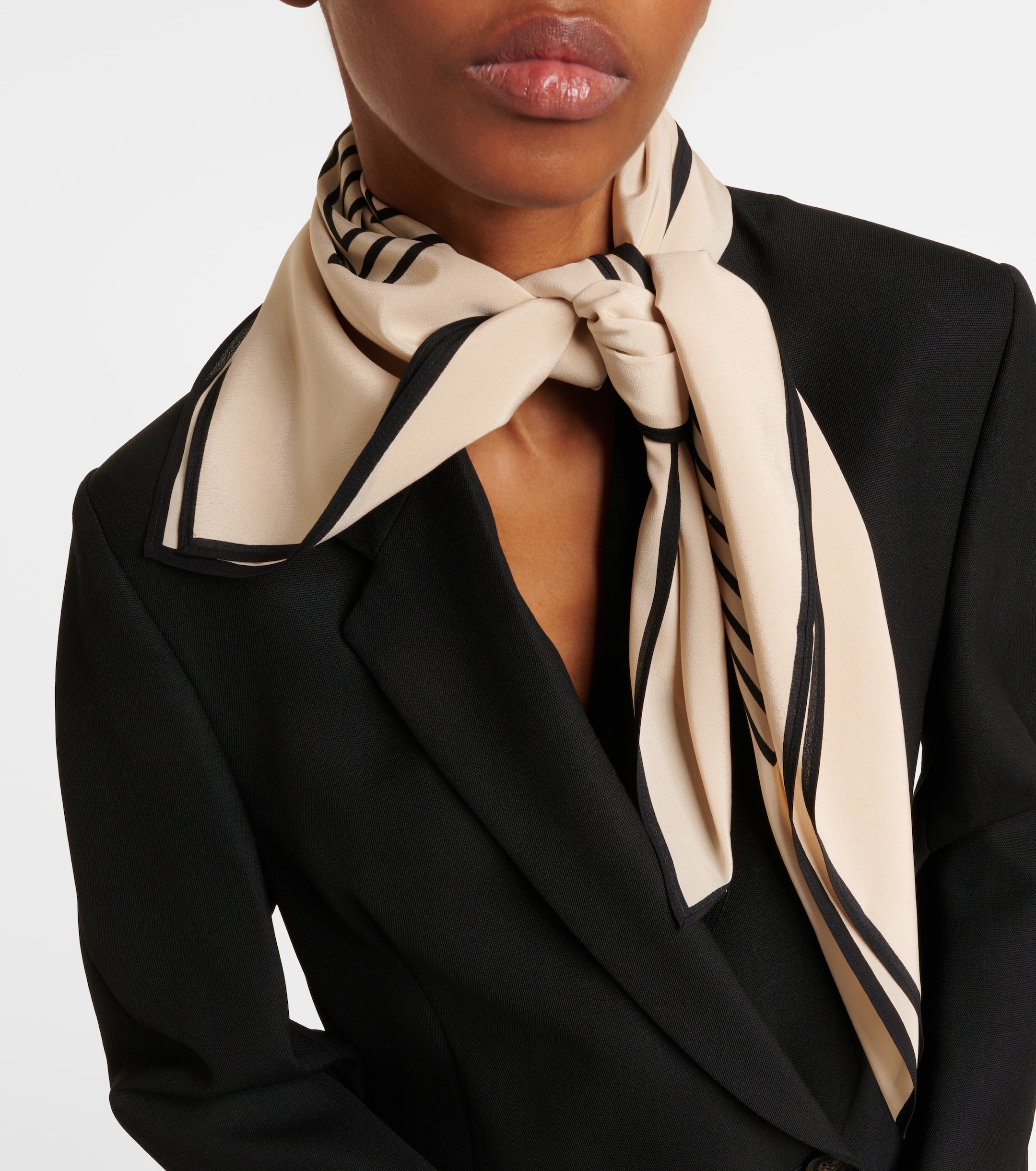 Monogram silk twill scarf adding texture to a neutral monochrome outfit