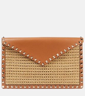 Rockstud Large leather-trimmed raffia clutch | Valentino Garavani