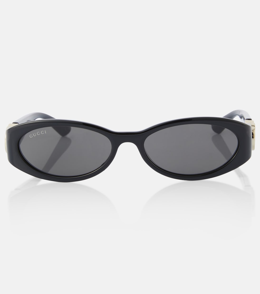 Occhiali da sole GUCCI con design ovale e logo intrecciato, stile giovane e moderno.