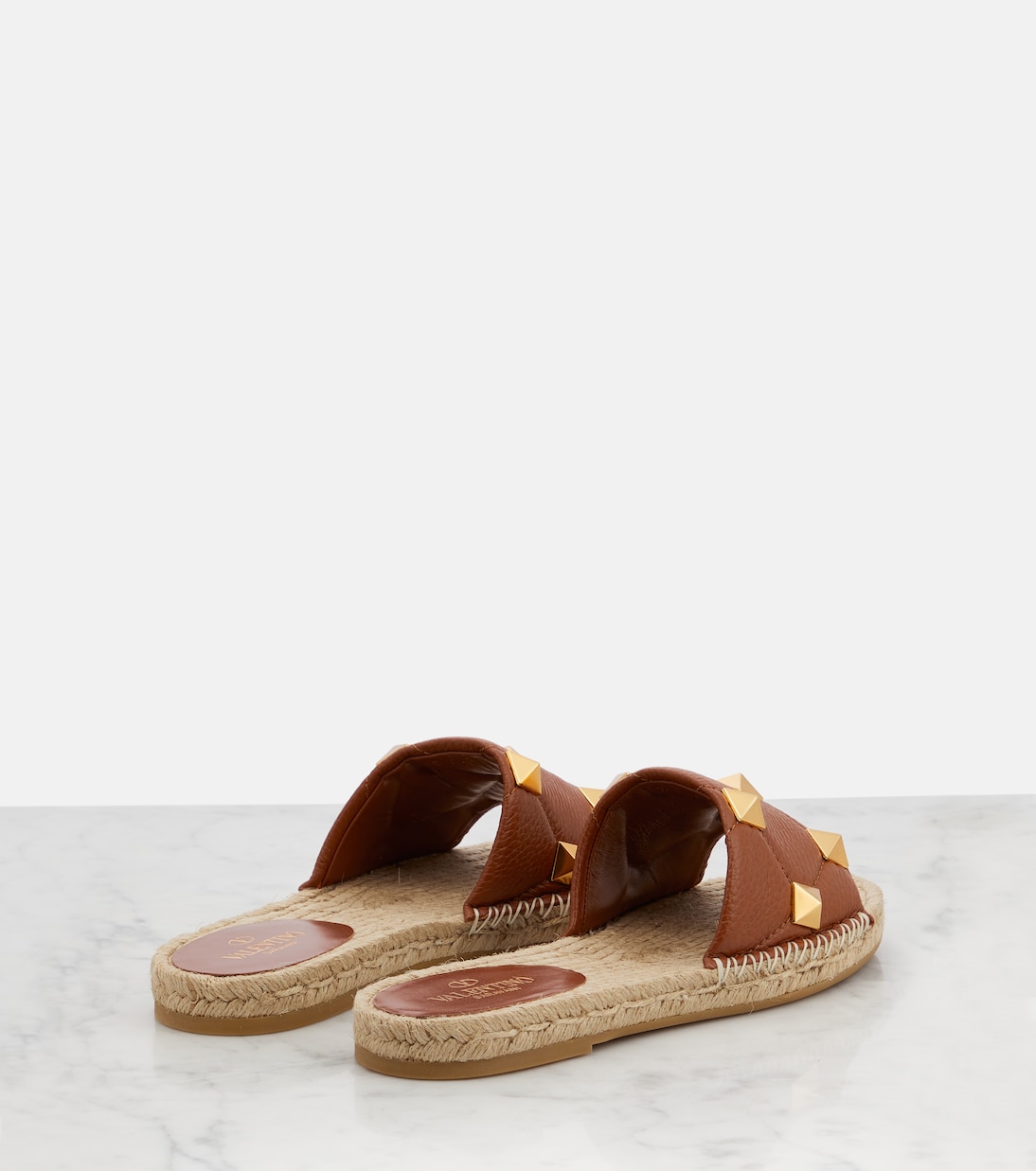 Roman Stud leather and raffia slides | Valentino Garavani