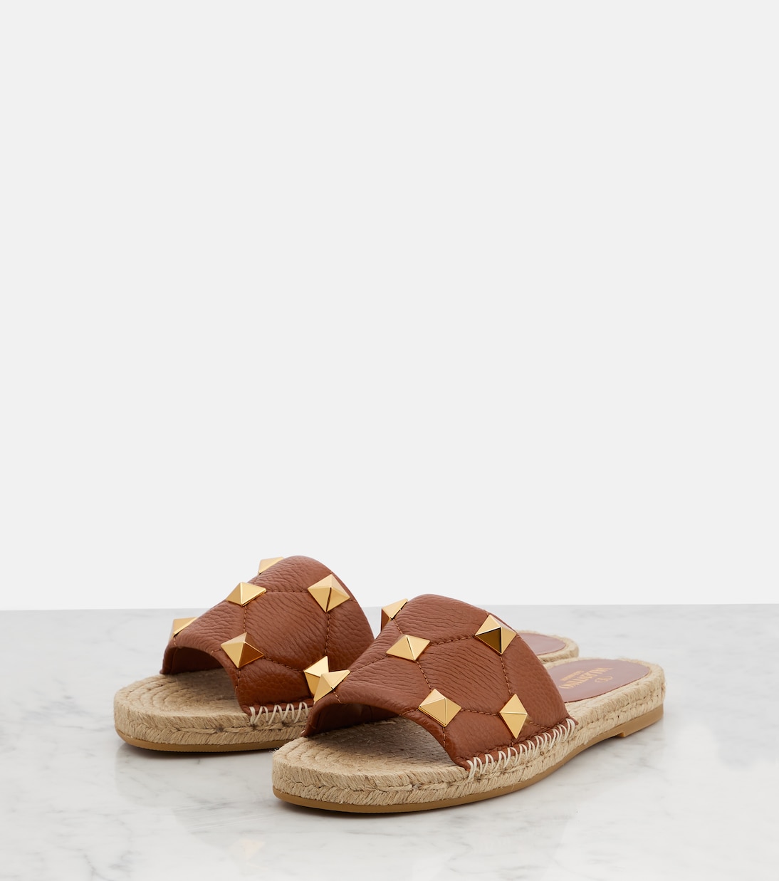 Roman Stud leather and raffia slides | Valentino Garavani