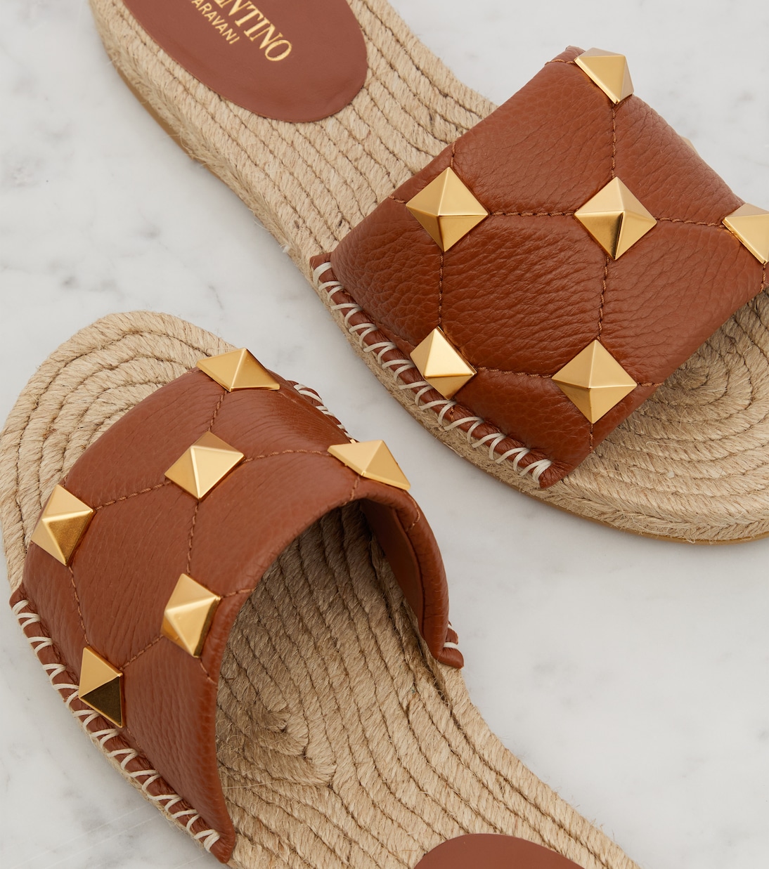 Roman Stud leather and raffia slides | Valentino Garavani