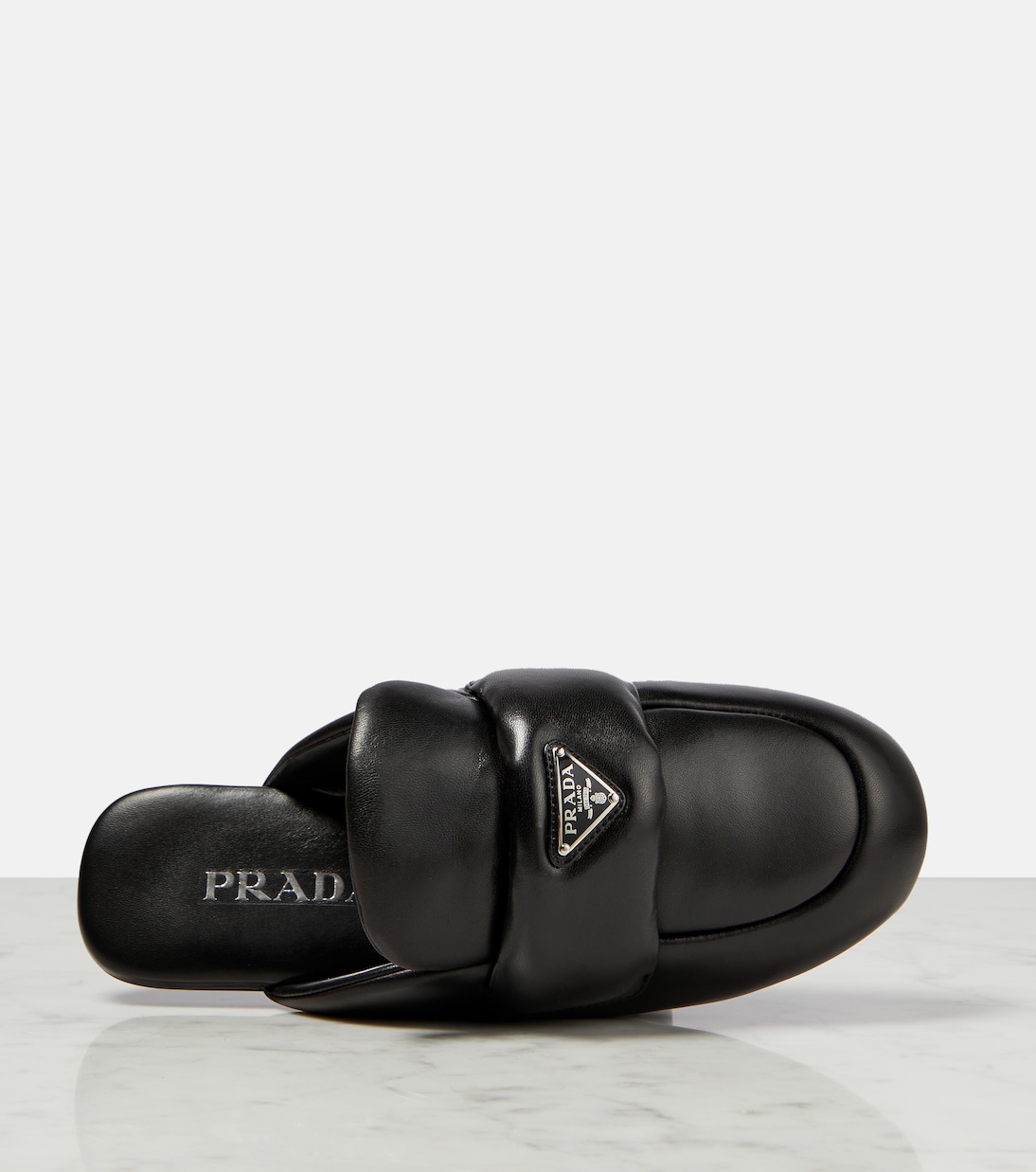 Padded leather slippers in black Prada Mytheresa
