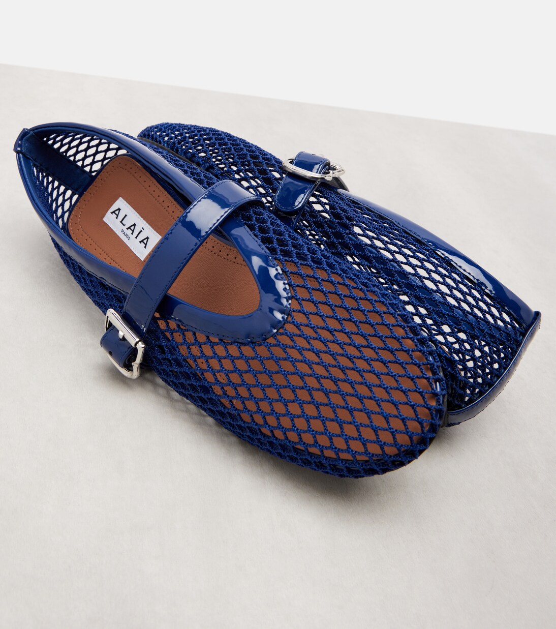 Patent leather-trimmed fishnet ballet flats | Alaïa