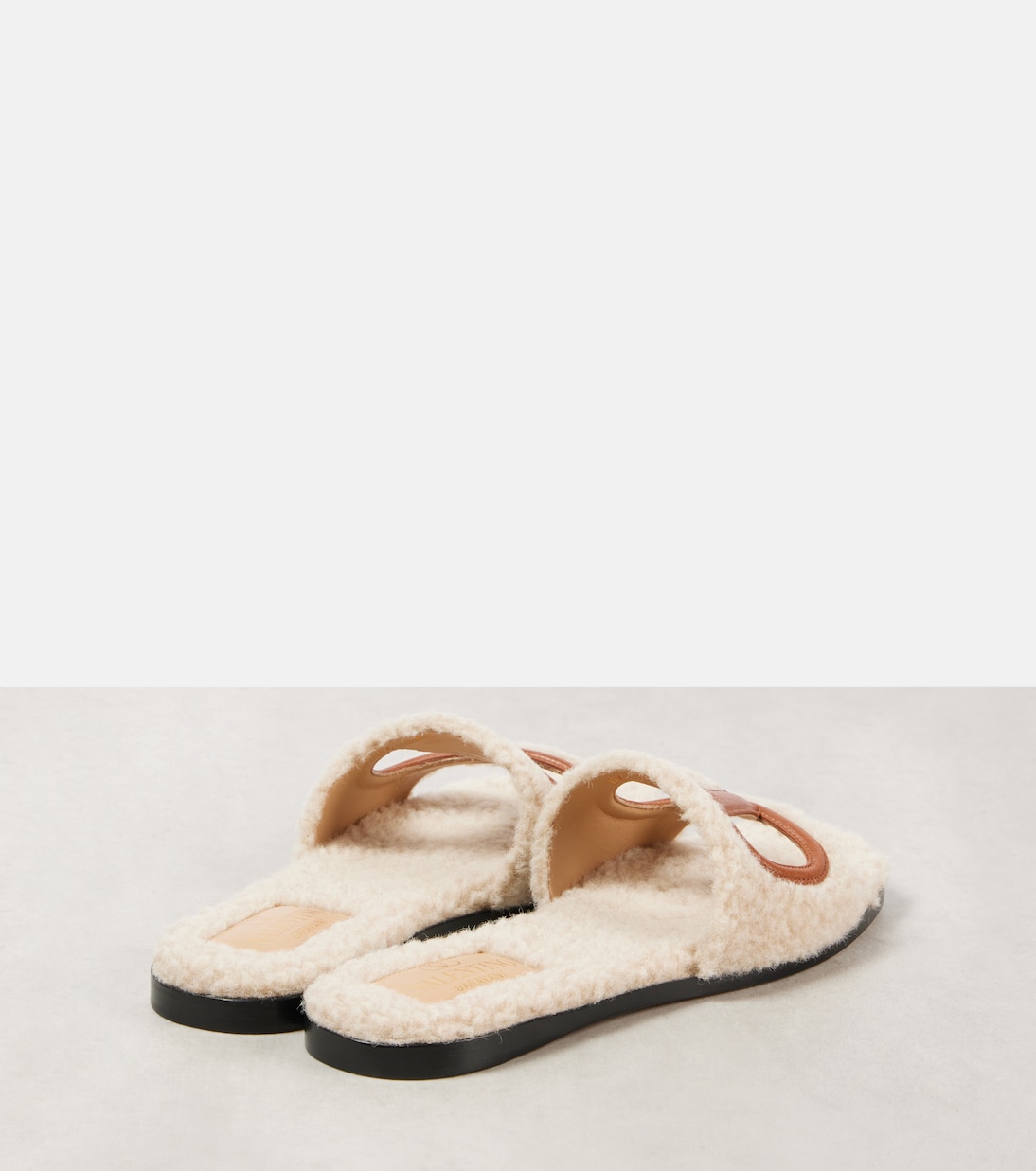 VLogo cutout faux shearling slides | Valentino Garavani