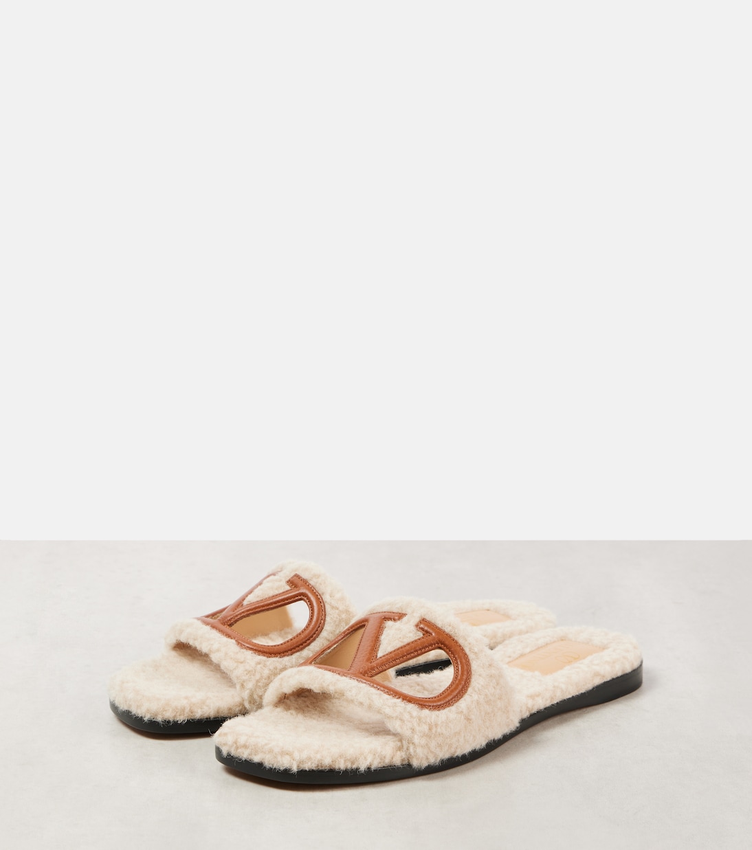 VLogo cutout faux shearling slides | Valentino Garavani