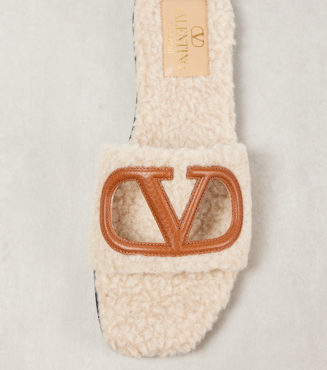 VLogo cutout faux shearling slides | Valentino Garavani