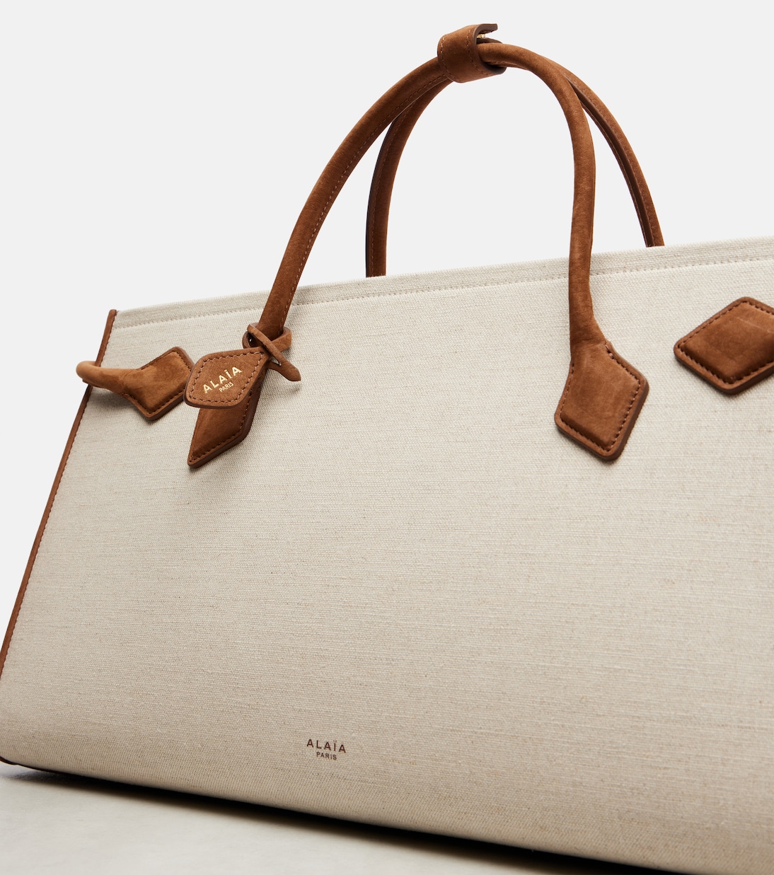 Le Teckel leather-trimmed canvas tote bag | Alaïa