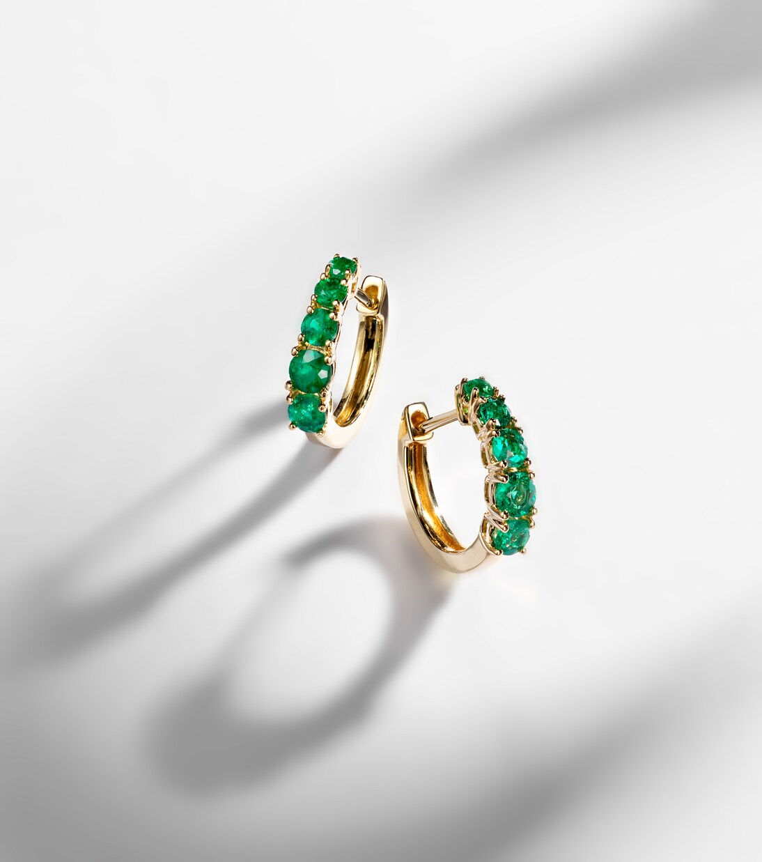 Graduated 18kt gold huggie earrings with emeralds | Anita Ko