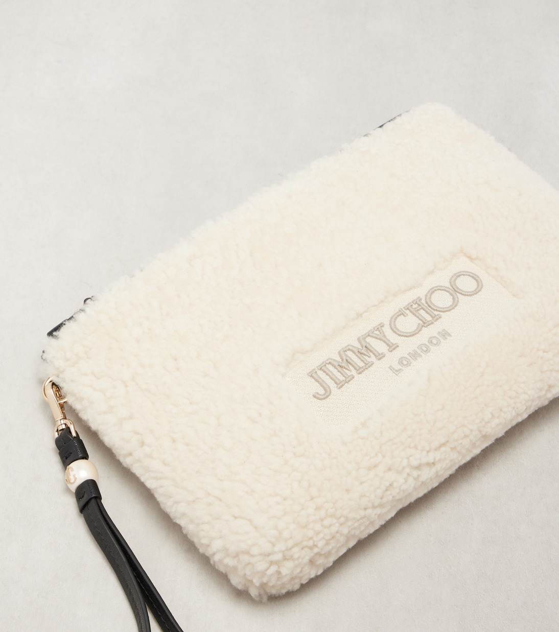 Bustina in shearling con logo e tracolla | Jimmy Choo
