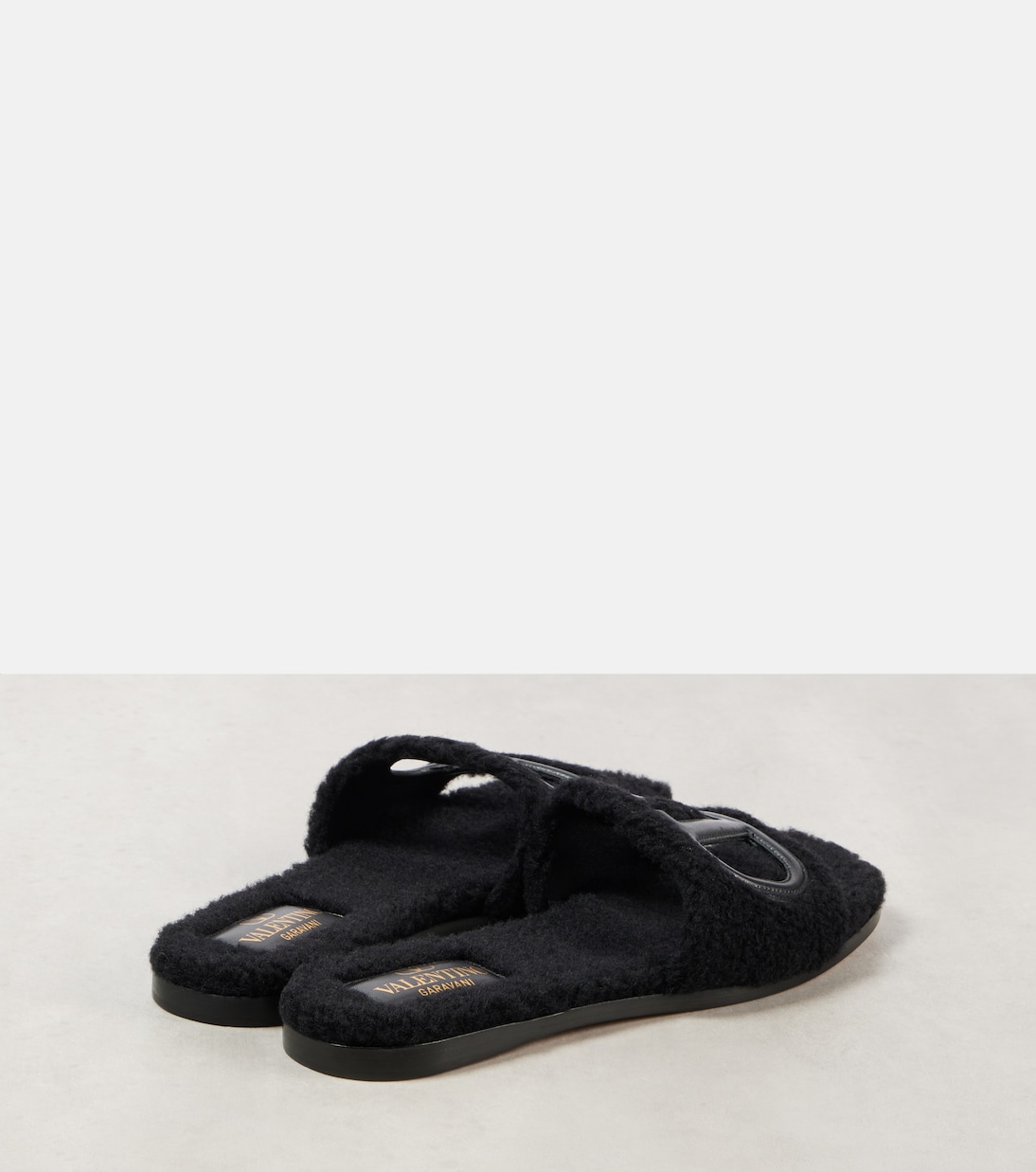 VLogo cutout faux shearling slides | Valentino Garavani
