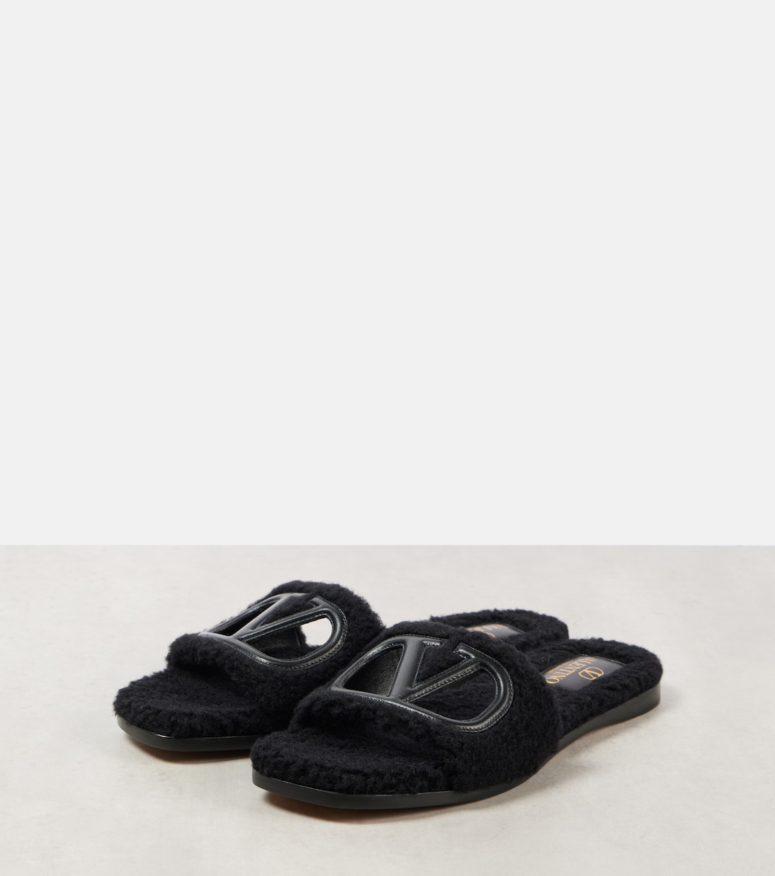 VLogo cutout faux shearling slides | Valentino Garavani