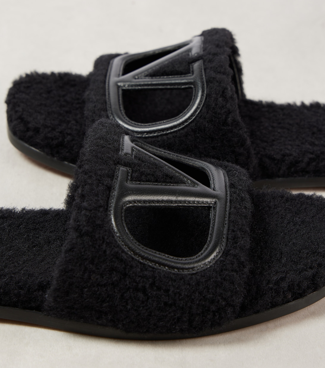 VLogo cutout faux shearling slides | Valentino Garavani