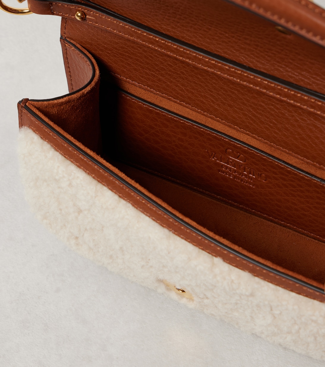Locò Small shearling and leather shoulder bag | Valentino Garavani