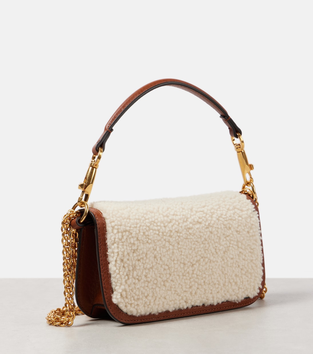 Locò Small shearling and leather shoulder bag | Valentino Garavani