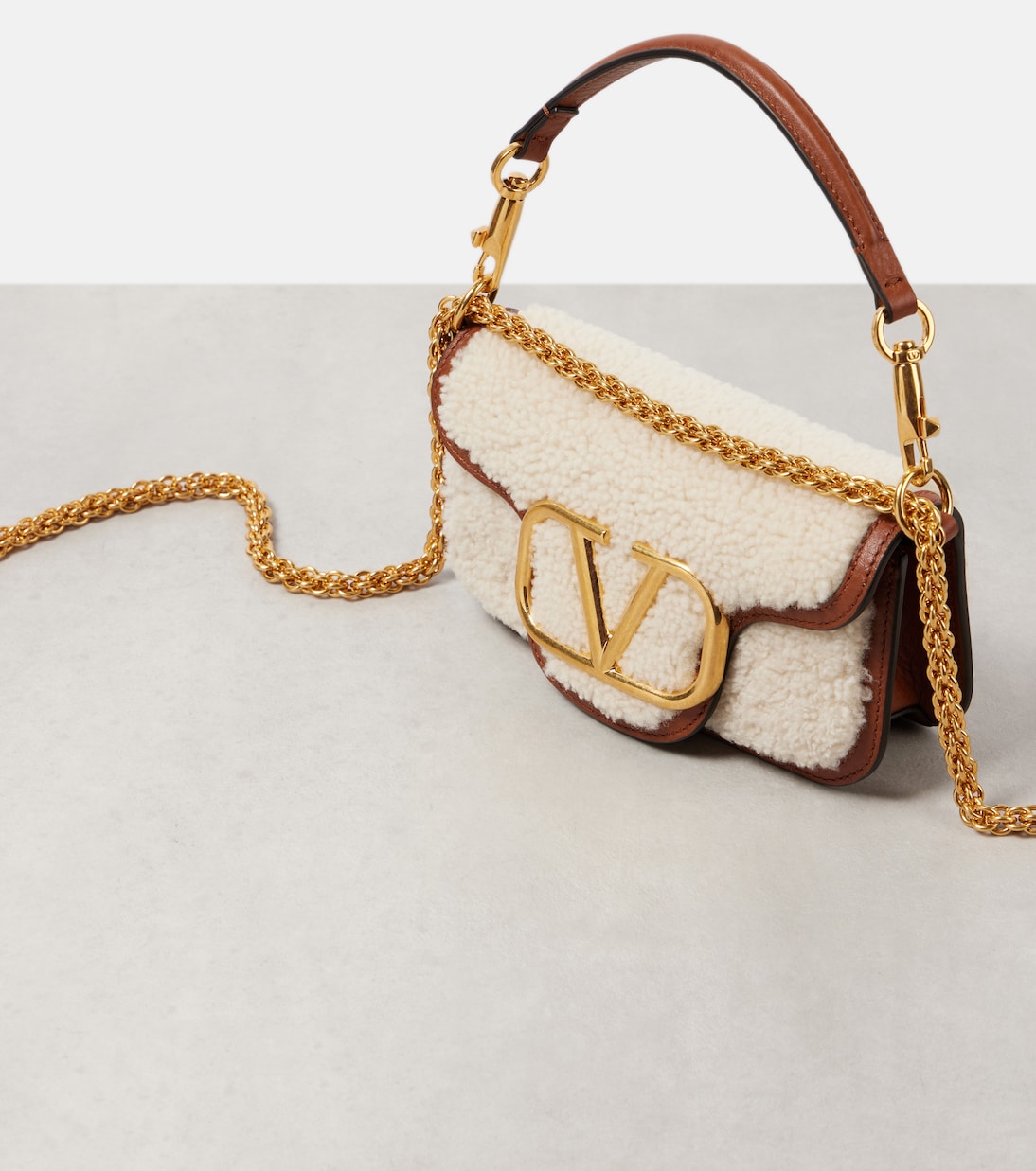 Locò Small shearling and leather shoulder bag | Valentino Garavani