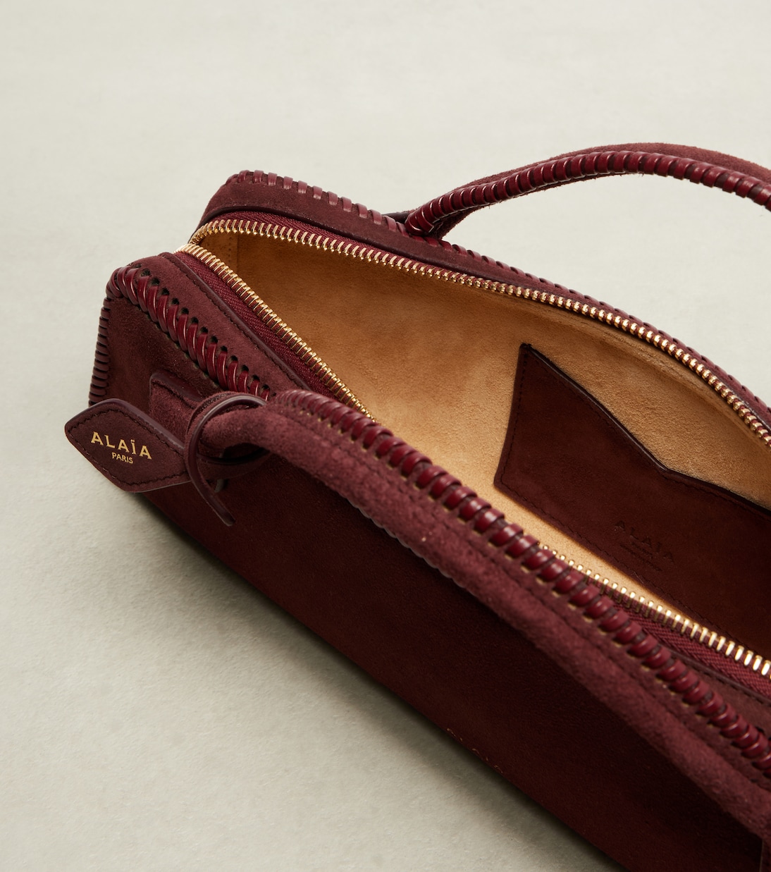Le Teckel Small suede clutch | Alaïa