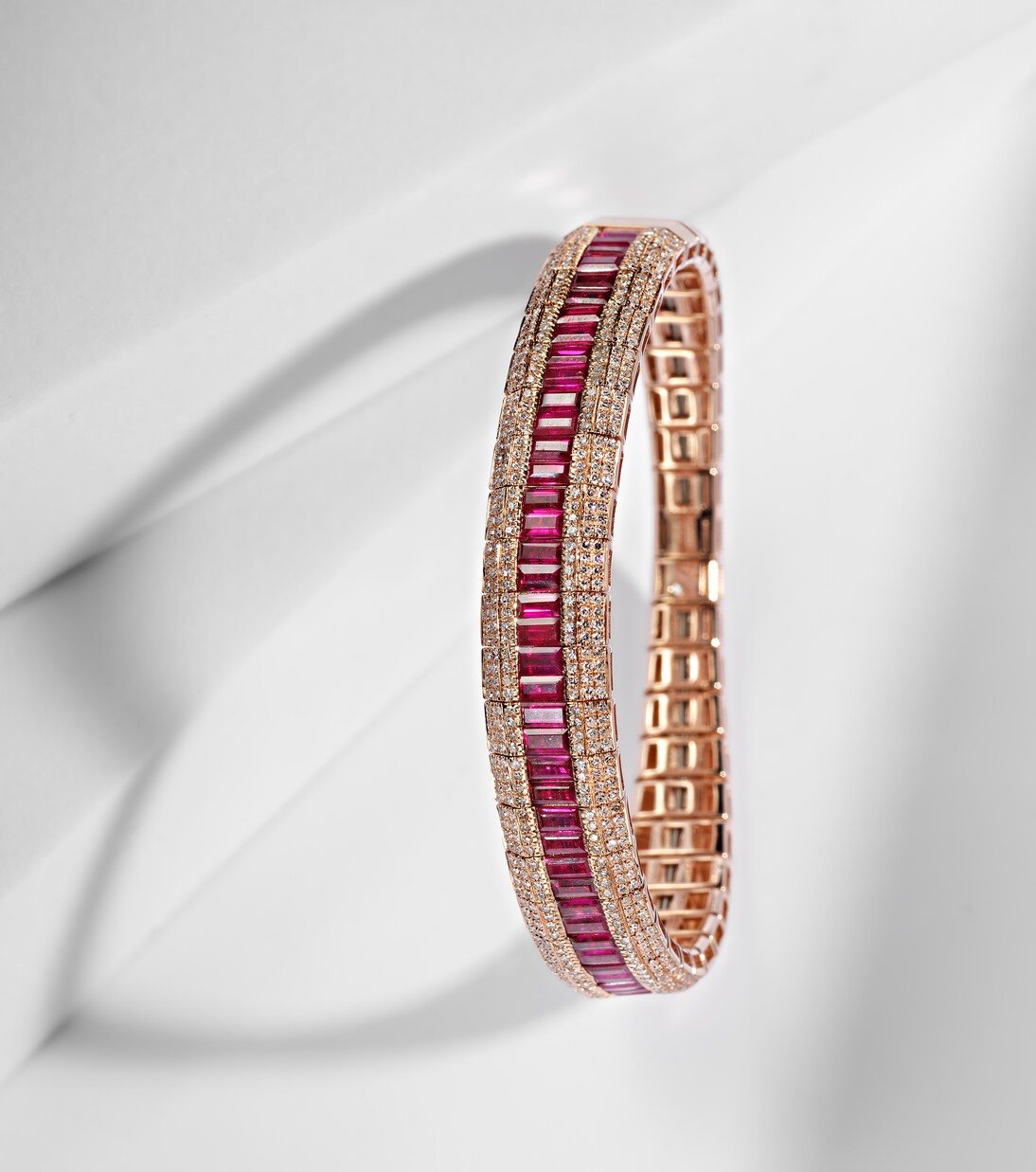 Bracciale in oro rosa 18kt con dettagli a scaglie, rubini e diamanti pavé, ideale per giovani trendy.