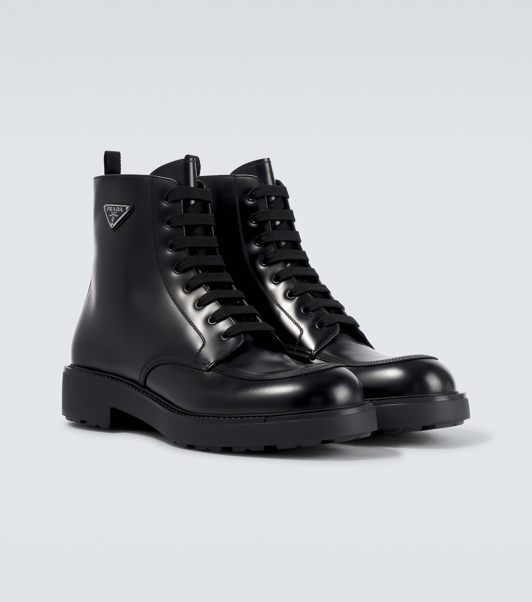 Logo brushed leather combat boots in black Prada Mytheresa