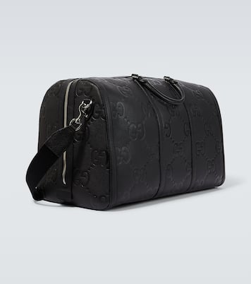 GG embossed leather duffle bag in black Gucci Mytheresa